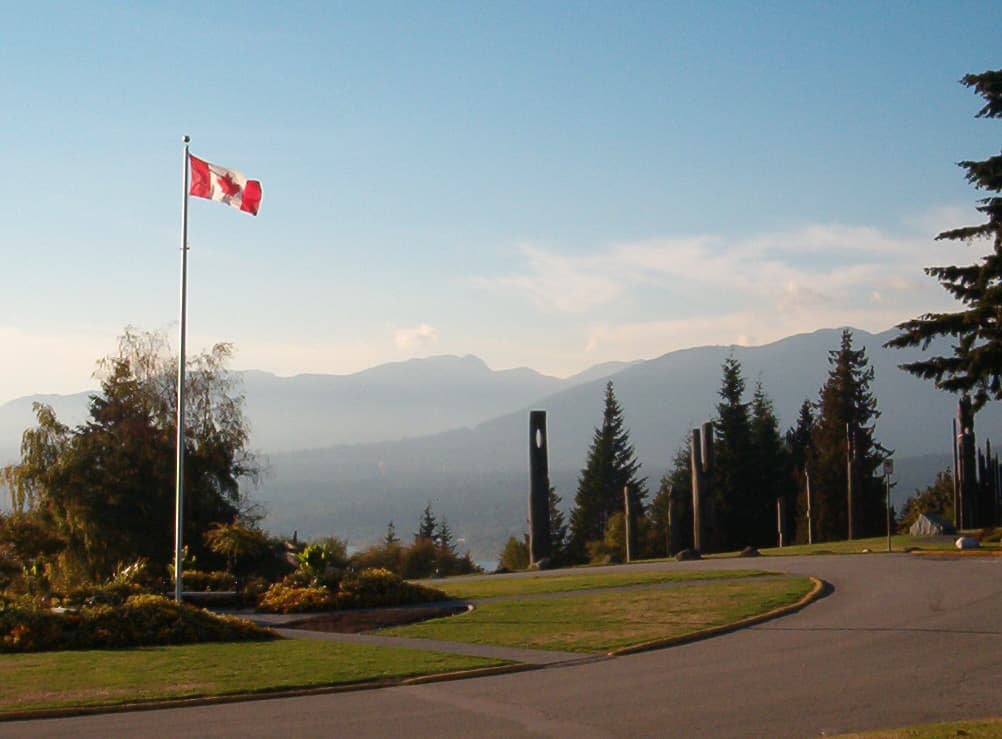 Aerial view of Burnaby Mountain, with the Simon Fraser University campus visible at the summit and the city of Burnaby stretching out below.