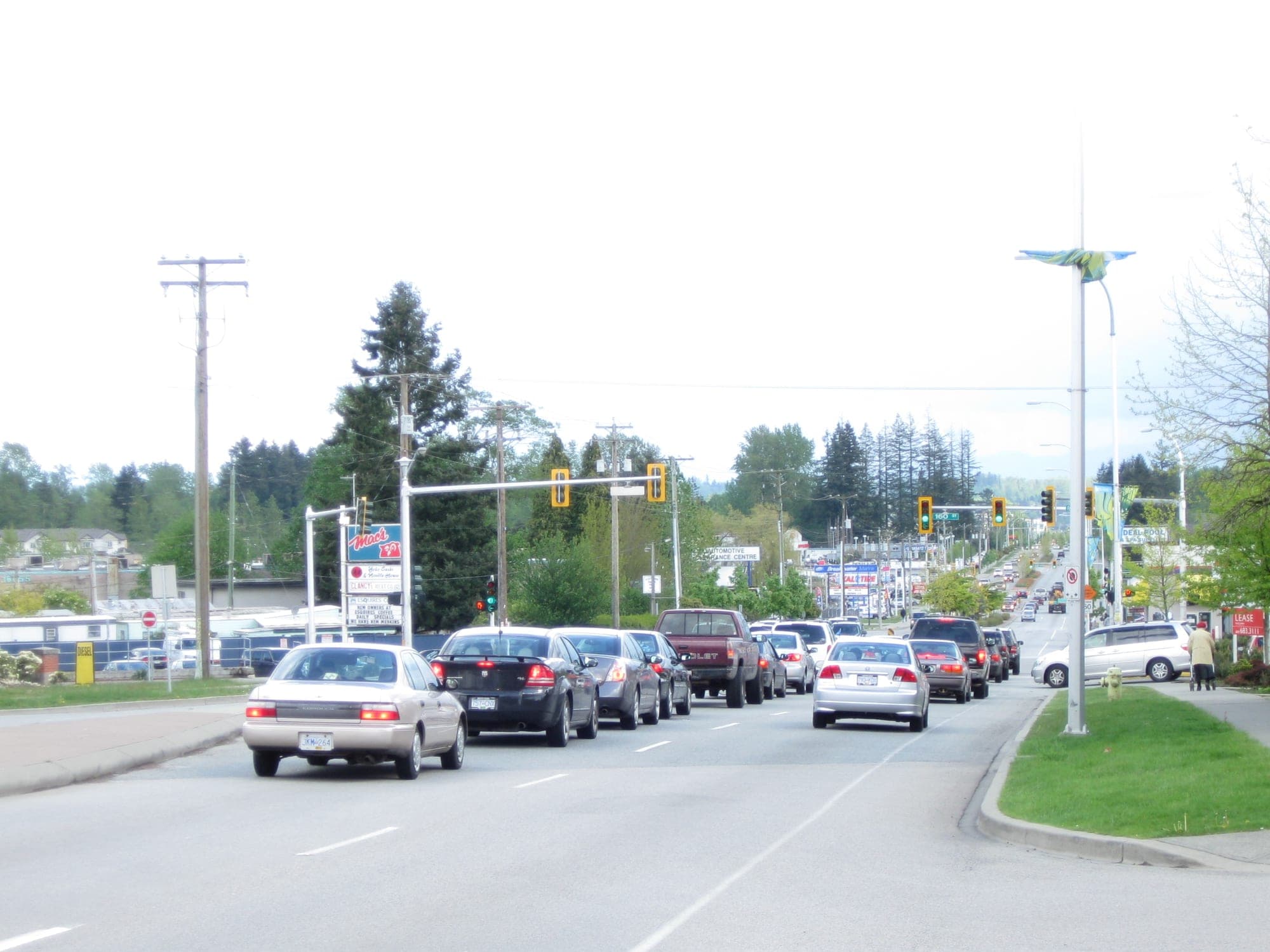 Fleetwood Town Centre in Surrey along Fraser Highway, with low-rise commercial buildings and street-level shops.